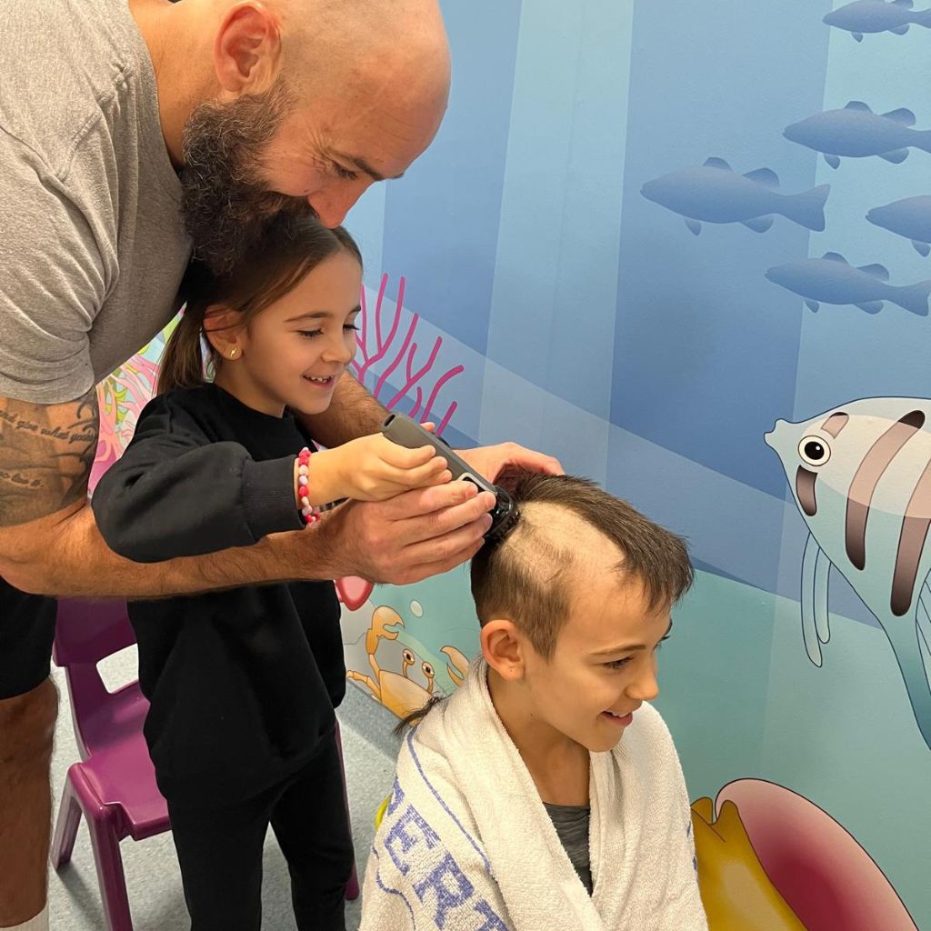 Ezra having his head shaved